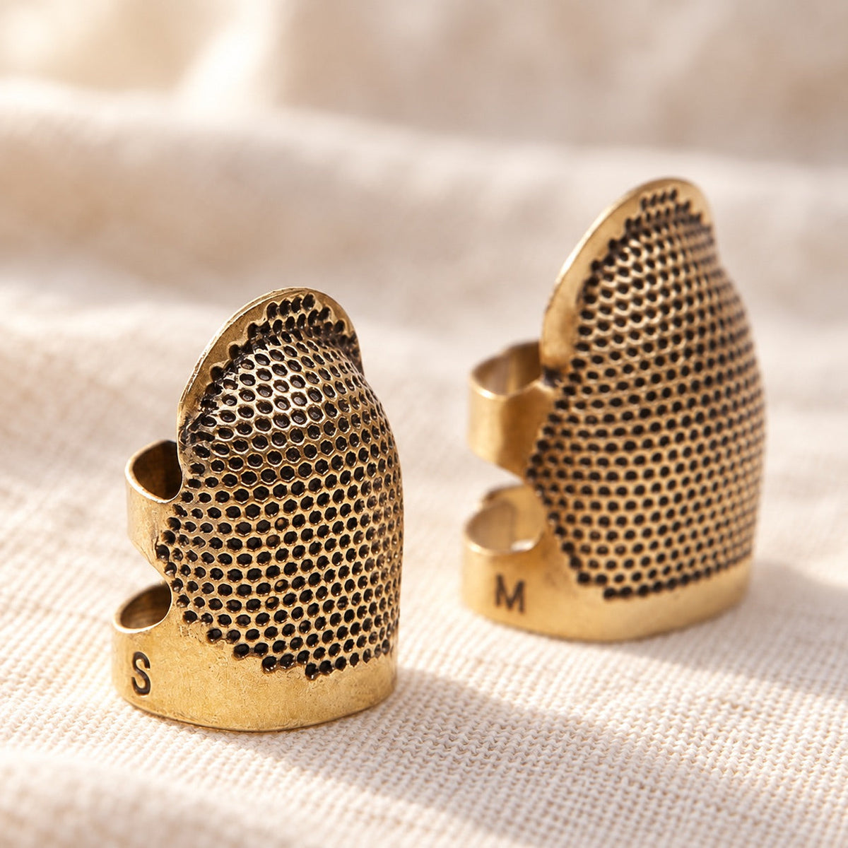 AI-styled: Adjustable Sewing Thimbles — S & M Pair — close view of the original product details. Styling props are not included.