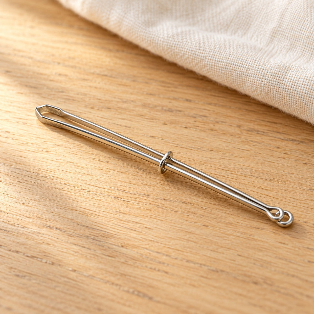AI-styled: Metal Elastic-Threading Bodkin on a warm oak craft desk. Styling props are not included.