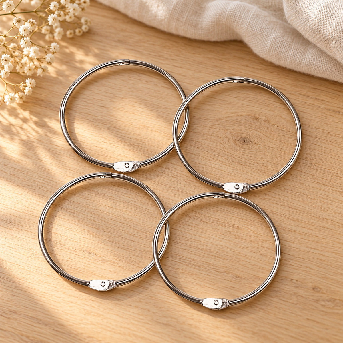 AI-styled: Floss Bobbin Storage Rings — Set of 4 on a warm oak craft desk. Styling props are not included.