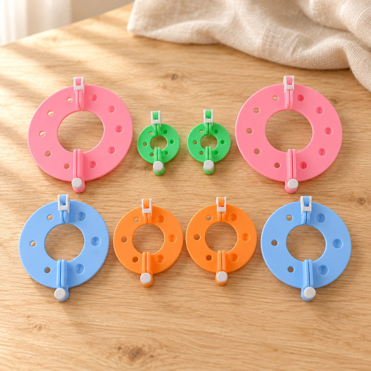 AI-styled: Pom-Pom Maker Set — 4 Sizes on a warm oak craft desk. Styling props are not included.